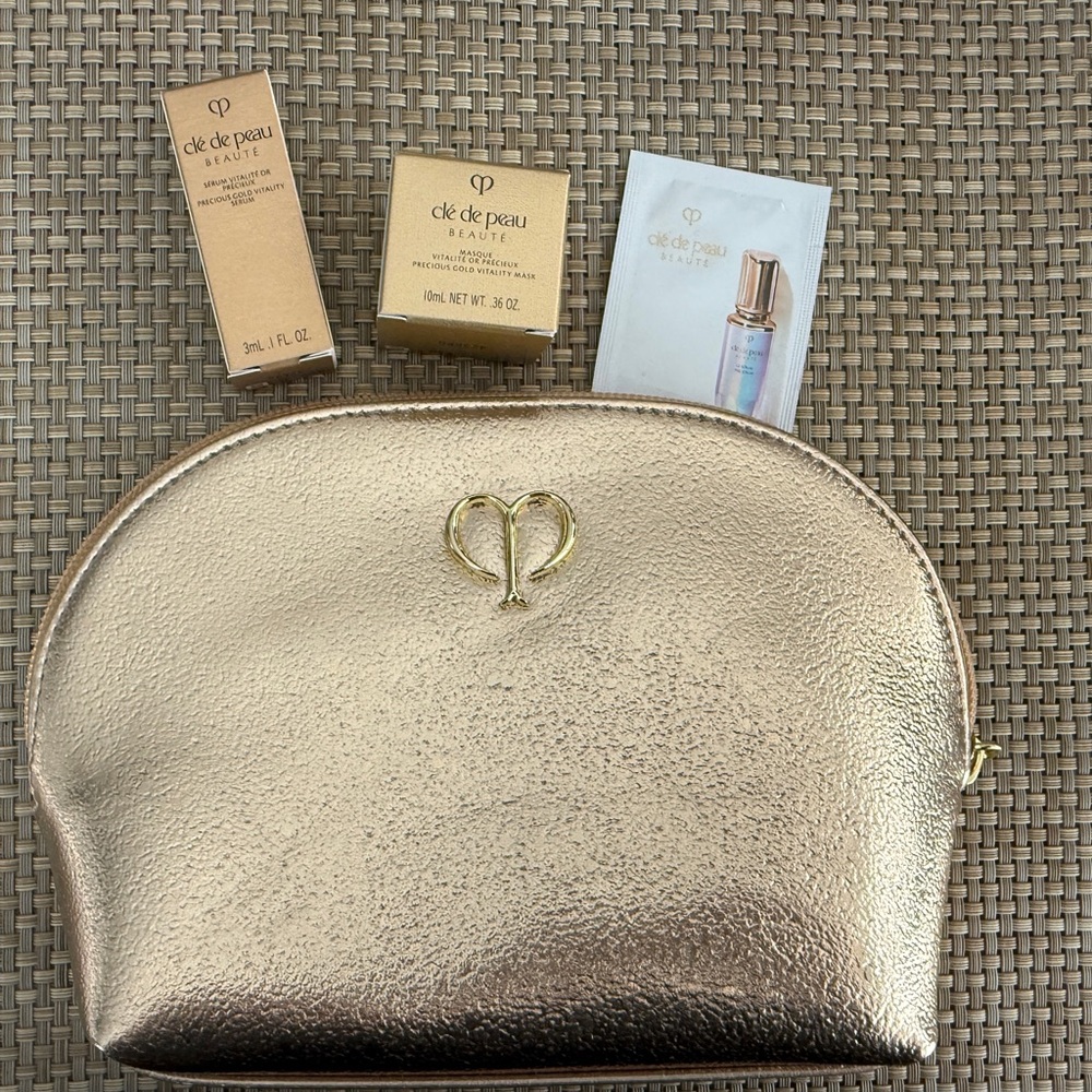 Brand New Cle de Peau Gold Makeup Pouch and Samples